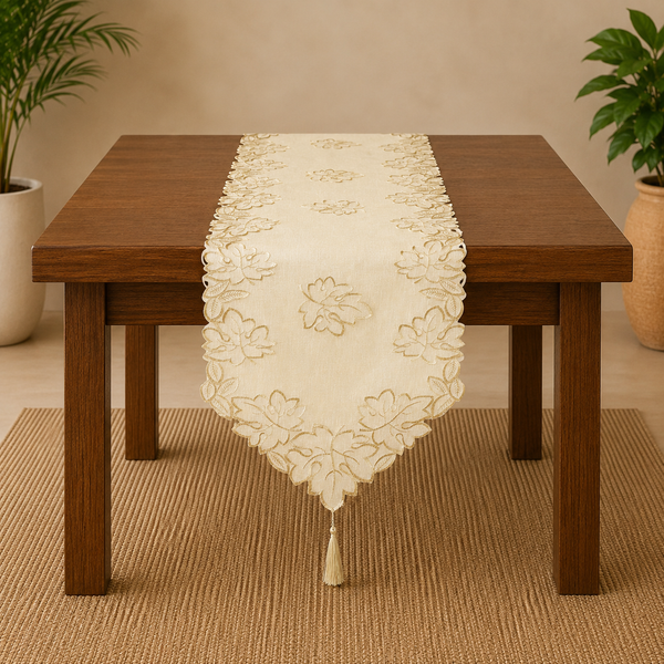 Wooden table with a decorative table runner in a room with plants.